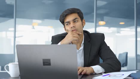 Indian-manager-working-in-an-office-and-thinking