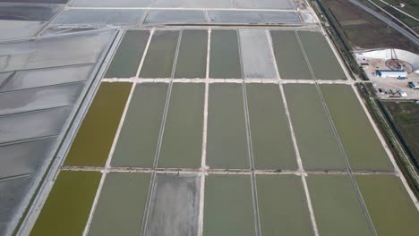 Salt-pools-texture-with-colorful-flat-rectangles-evaporating-water-near-Adriatic-sea-coastline-in-Albania