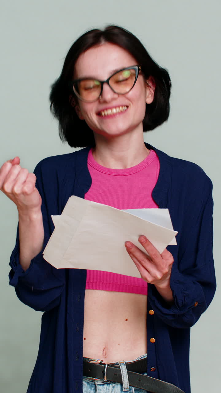 Young woman opening letter gradually smiling more expressing joyful news lottery win test results