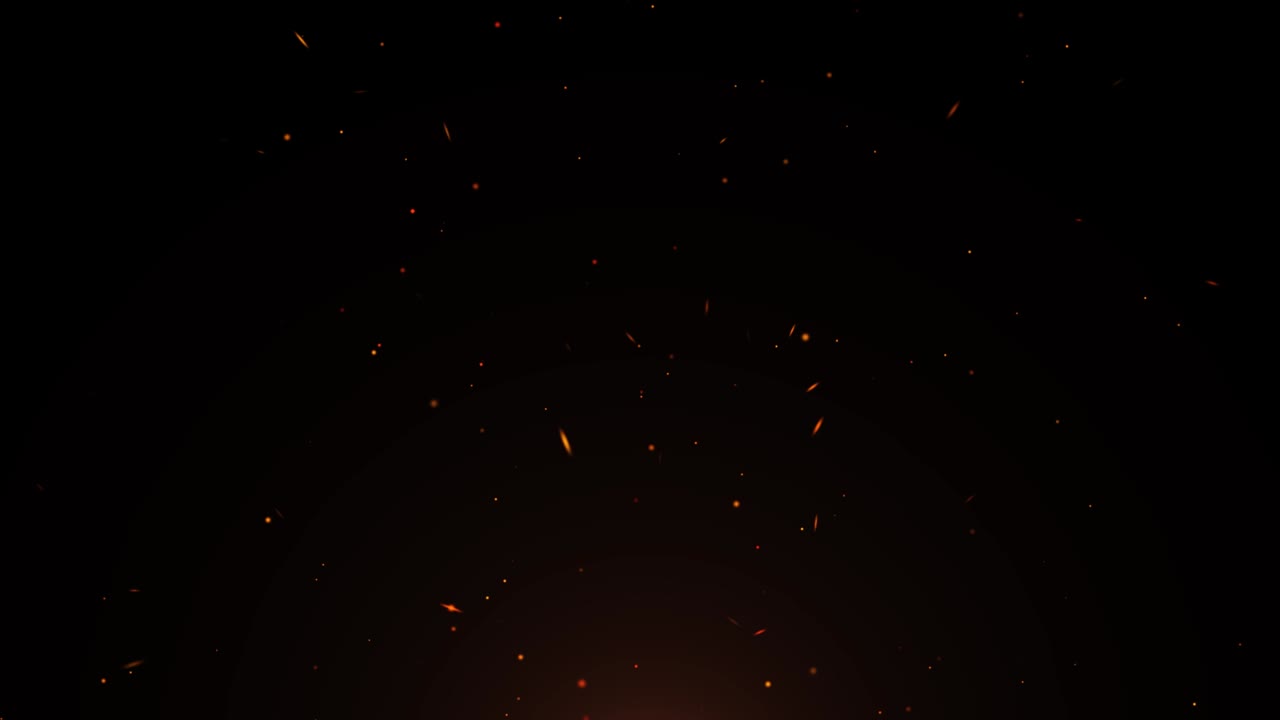 las partículas de llamas calientes que queman las chispas del fuego de la hoguera en un fondo de bucle oscuro.