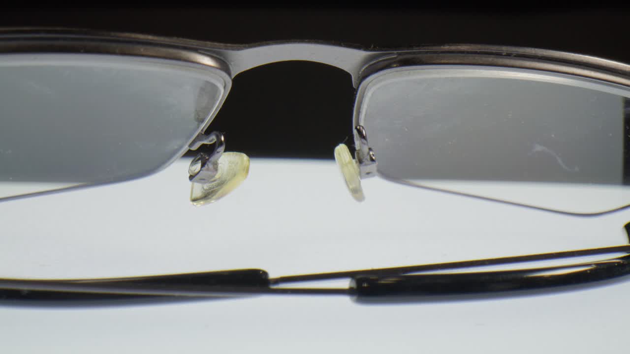 Reading glasses with macro video close up moving in a circle.