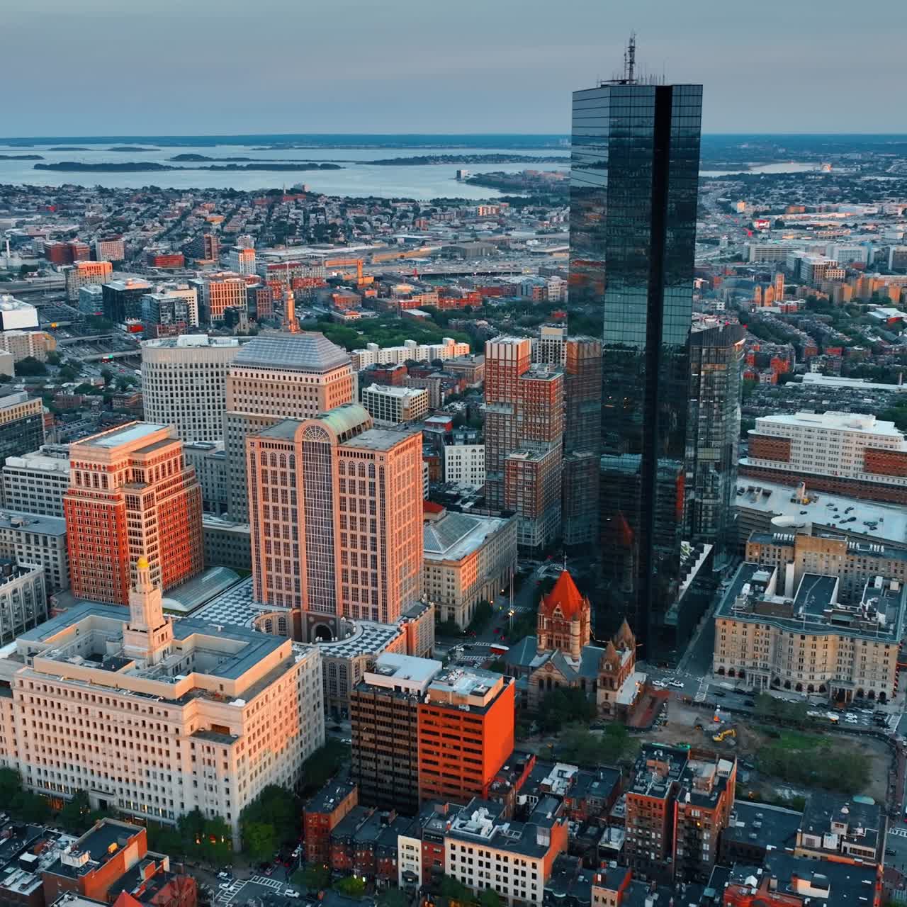 John Hancock Tower standing out in the architectural ensemble of Boston downtown. Stunning scenery of American metropolis after sundown. Top view