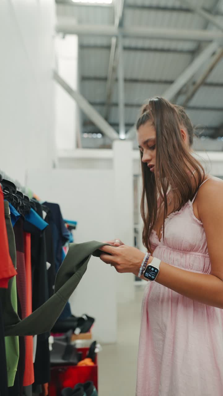 A woman looking at clothes on a rack