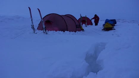 campers in deep snow on an arctic expedition at night