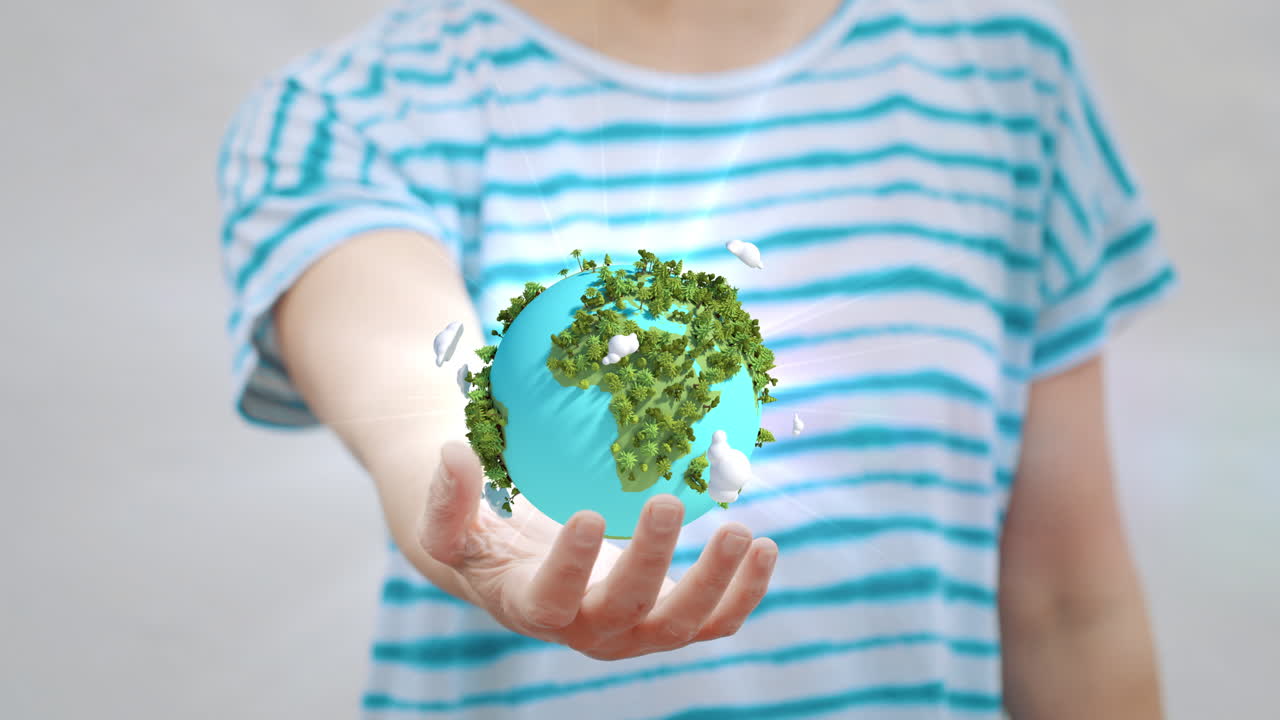 Mano humana sosteniendo un globo terráqueo verde giratorio