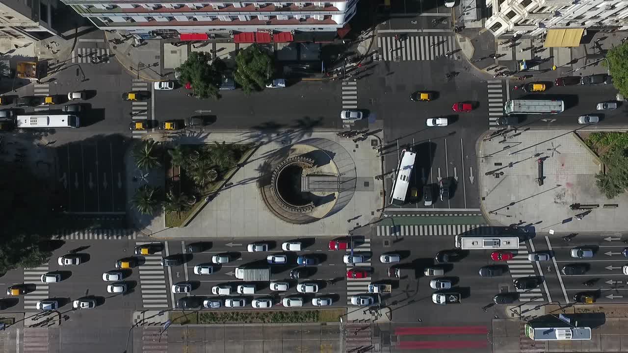Aerial shot moving away from the 9 de Julio Avenue of Buenos Aires Argentina during the day with flowing traffic