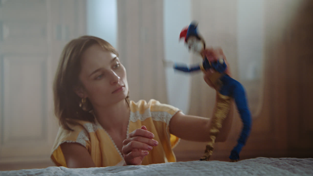 A girl playing with dolls in her room
