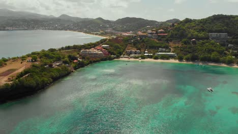 Aerial-view-of-Mourne-Rouge-Beach,-Grenada-with-a-cloudscape-in-the-background