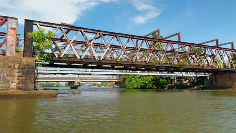 rusty railway bridge over a river