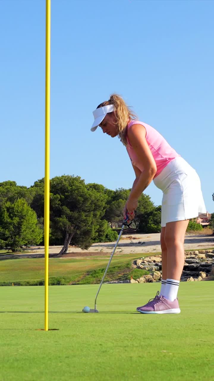 Woman Golfer Putting on Golf Course