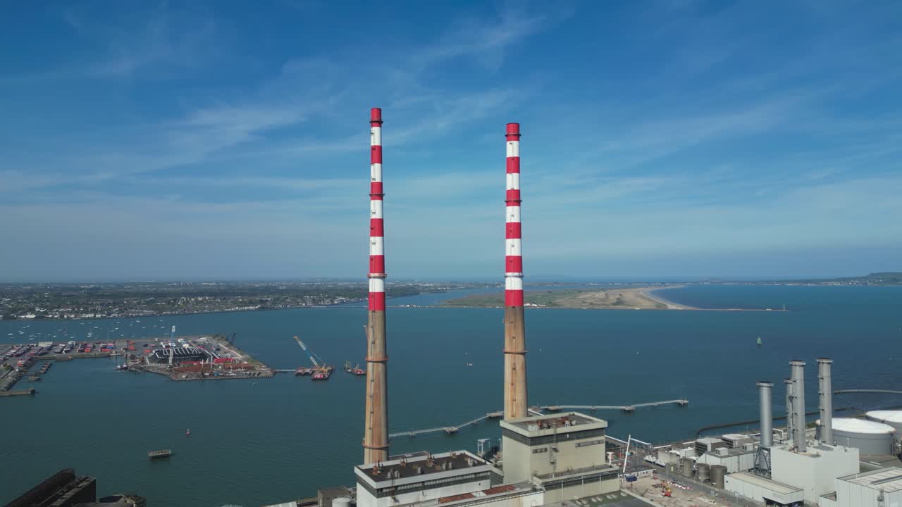 Poolbeg Stacks at decommissioned power station on Poolbeg Peninsula, Dublin Bay, orbiting wide angle aerial view