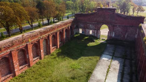 aerial view of former russian tsar army gymnastics hall in karosta, liepaja, used for gymnastics performances and competitions for horseback riders, wide angle birdseye drone shot moving forward