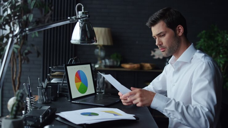 Surprised businessman analyzing business documents