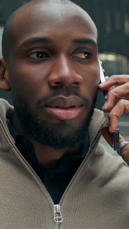 man talking on phone in city