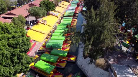 an aerial view of colourful mexican boats for trips through the xochimilco channels in mexico city