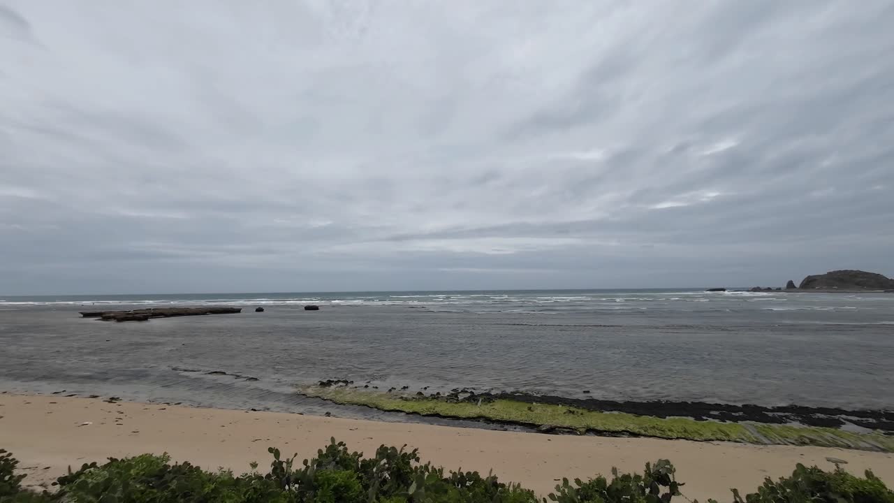 Wide panoramic view of My Hoa Lagoon in Vietnam on a cloudy day, showing calm shallow sea, sandy coastline and peaceful tropical atmosphere, ideal coastal scenery for travel and nature concepts