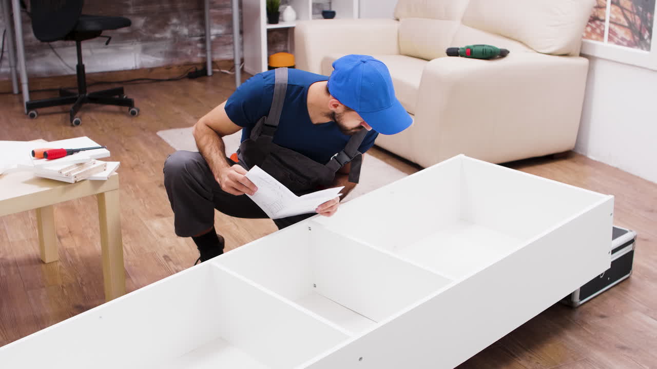 Man Assembling Furniture with Instruction Manual