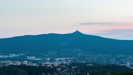 Timelapse-of-Liberec-city-with-Jested-in-the-evening,-zoom-view,-Czech-Republic