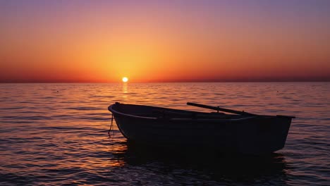 a serene sunset over calm waters with a silhouetted boat: capturing the tranquil beauty of nature and the peaceful evening atmosphere