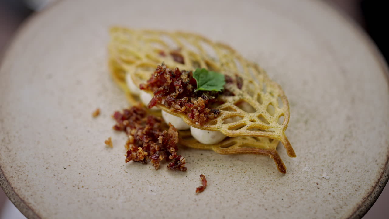 Exquisite leaf-shaped food presentation with bacon and mint