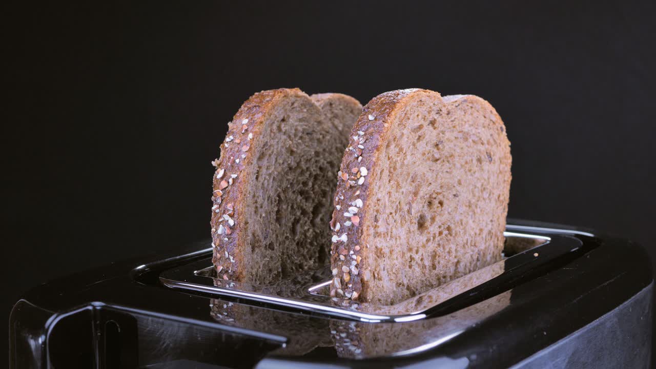 Toast popping up from toaster. Close up