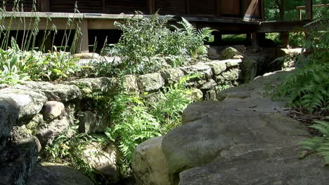 rock-lined drainage channel behind a japanese house