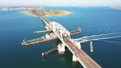 an aerial shot over an elevated train track with a swing bridge