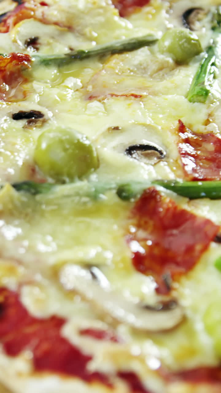 Italian pizza on wooden table with vegetables and spices