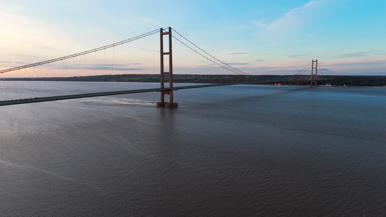 Serenity in motion: Humber Bridge with cars at the sunset's edge