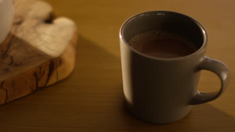 close up of steaming cup of hot chocolate drink on table 1