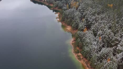 tranquil drive: a scenic roadside experience blending the elegance of snow, autumn colors, and moody vibes by the lake and forest