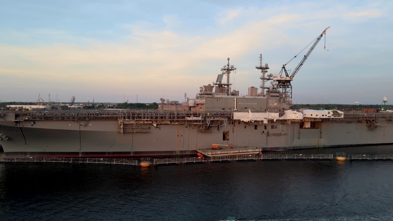 Aerial View Of Aircraft Carrier Docked At General Dynamics Nassco Shipyard In Norfolk, Virginia. Dolly Forward Rising Shot