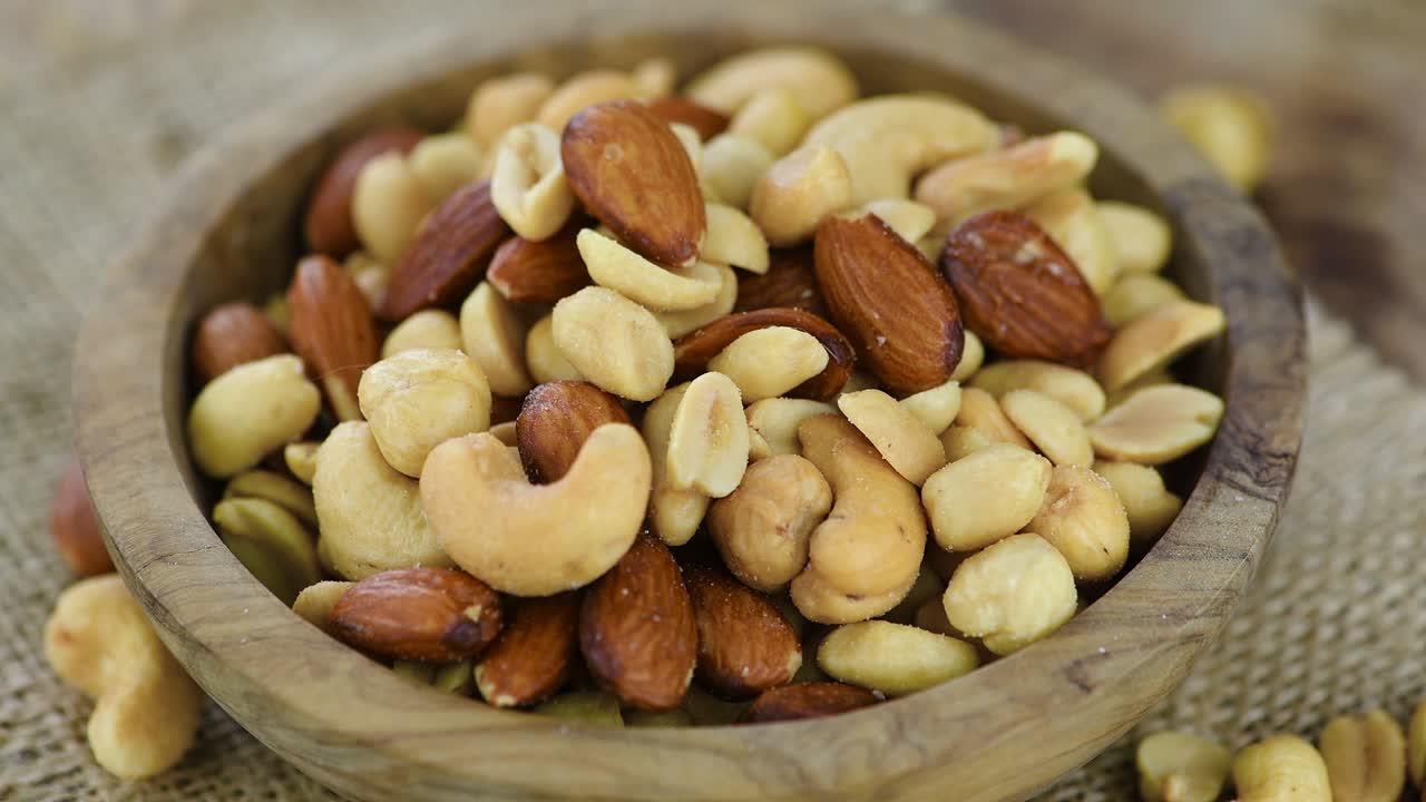 Freshly roasted nuts on a rotating plate (seamless loopable)