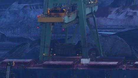 closeup, bulk coal being transferred by machinery into storage facility
