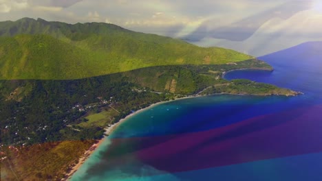 Digital-composition-of-waving-columbia-flag-against-aerial-view-of-the-sea