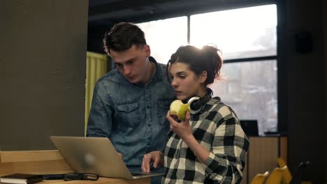 cute couple of two young attractive people using laptop. full concentration. spending time together.