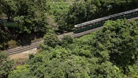 aerial following the peak tram as it makes its down from victoria peak, hong kong