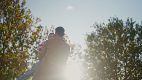 Father and Daughter Playing in the Fall