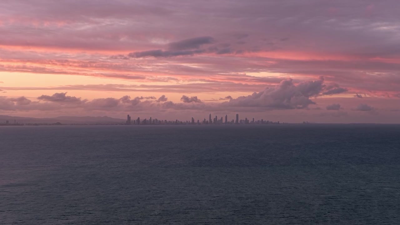 Modern Skyscrapers Of Surfers Paradise In Distance Across The Ocean During Sunset In Gold Coast, QLD. wide shot