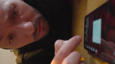 man intensely focused on his phone screen