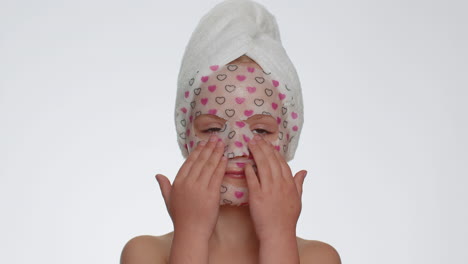 Child-girl-applying-cosmetic-moisturizing-face-mask,-teenager-skin-care-treatment,-natural-cosmetics