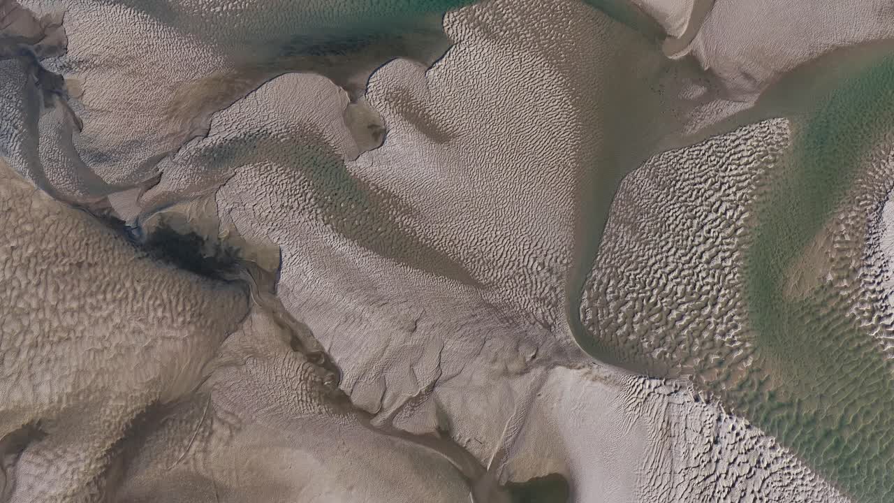 Low tide reveals amazing sand shapes on river estuary