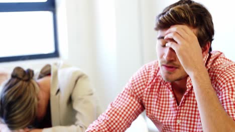 Stressed-executives-sitting-at-desk