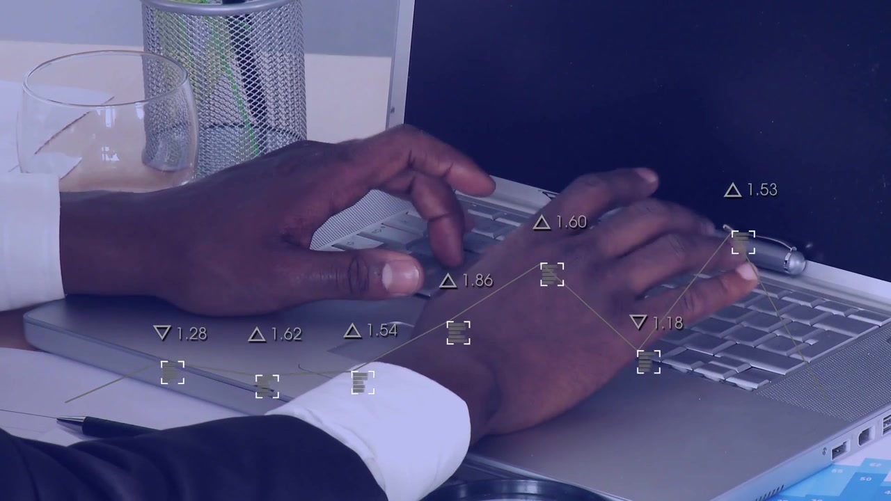Vertical video: Hands suit cuff poised typing on laptop at desk, overlay tracking fingers and pen
