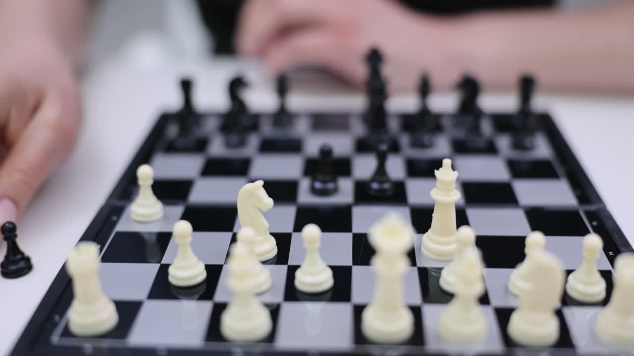 Person Playing Chess on a Chessboard