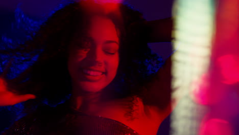 Close-Up-Of-Young-Woman-In-Nightclub-Bar-Or-Disco-Dancing-With-Sparkling-Lights-1