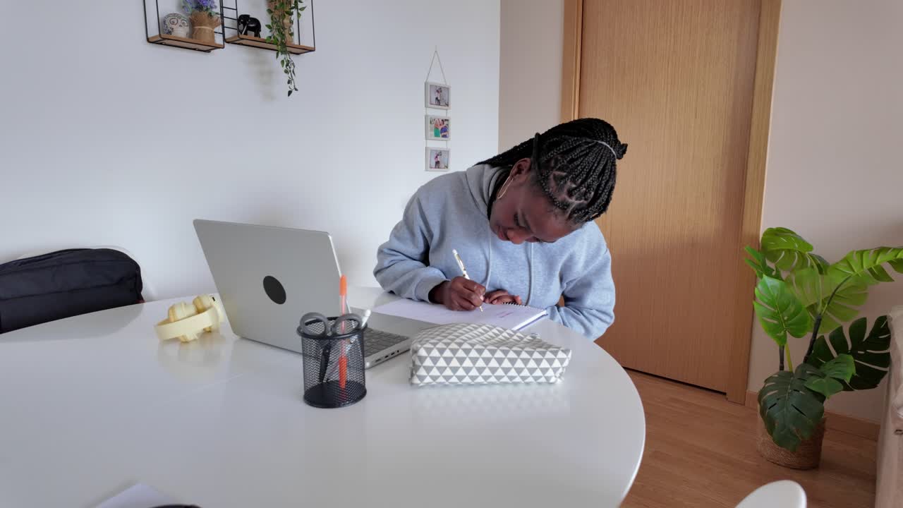 Person Studying at Desk with Laptop