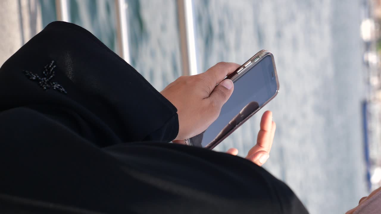 Woman using smartphone on a boat
