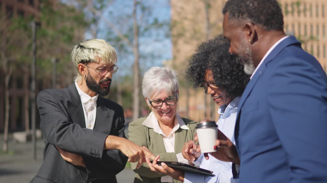 African businesswoman using digital tablet to explain a project outdoors