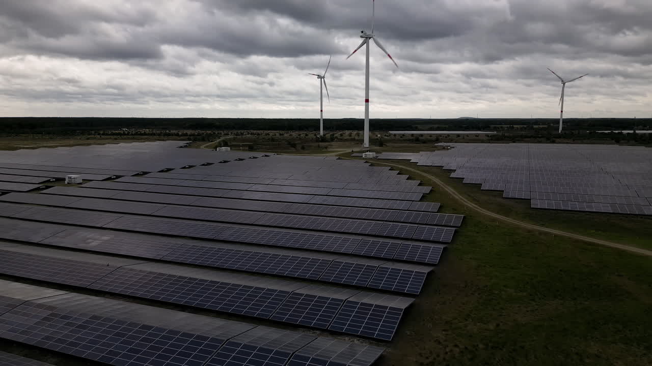 Solar and wind energy generated in fields of Belgium, aerial view
